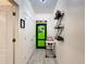 Hallway featuring a green game room door and built-in shelving at 2477 Shanti Dr, Kissimmee, FL 34746