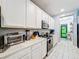 Well-equipped kitchen with white cabinets and granite counters at 2477 Shanti Dr, Kissimmee, FL 34746