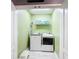 Convenient laundry room with washer, dryer, and ample shelving at 2477 Shanti Dr, Kissimmee, FL 34746