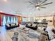 Open concept living room with seating and large windows at 2477 Shanti Dr, Kissimmee, FL 34746