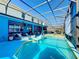 Lush pool area with plenty of seating and a movie screen at 2477 Shanti Dr, Kissimmee, FL 34746