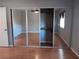 Bedroom with mirrored closet doors and wood floors at 2860 N Powers Dr # 8, Orlando, FL 32818