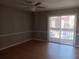 Living room with wood floors and sliding glass doors to balcony at 2860 N Powers Dr # 8, Orlando, FL 32818