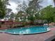 Community swimming pool surrounded by lush landscaping at 2860 N Powers Dr # 8, Orlando, FL 32818