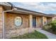 Front entrance of brick home with a blue door and landscaping at 4547 Winderwood Cir, Orlando, FL 32835