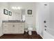 Bathroom with granite countertop, white tub and shower at 5368 Diplomat Ct # 104, Kissimmee, FL 34746
