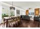 Dining area with a rustic wooden table, chairs, and a view into the living room and kitchen at 5368 Diplomat Ct # 104, Kissimmee, FL 34746