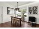 Bright dining room with a wooden table, chairs, and a large mirror reflecting light at 5368 Diplomat Ct # 104, Kissimmee, FL 34746