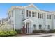 Two-story light-blue townhome with dark-brown trim and a small front yard at 5368 Diplomat Ct # 104, Kissimmee, FL 34746