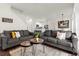 Open living room with two gray sofas, a coffee table, and views into the kitchen and dining areas at 5368 Diplomat Ct # 104, Kissimmee, FL 34746