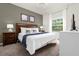 Spacious bedroom with a king-size bed, nightstands, and a large window at 5368 Diplomat Ct # 104, Kissimmee, FL 34746