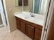 Bathroom vanity with wood cabinets and granite countertop at 602 Mesilla Dr, Kissimmee, FL 34758