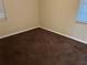 Simple carpeted bedroom with neutral walls and window at 602 Mesilla Dr, Kissimmee, FL 34758