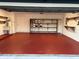 Garage with red epoxy flooring and built-in shelving at 602 Mesilla Dr, Kissimmee, FL 34758