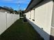 Landscaped side yard with white vinyl fence at 602 Mesilla Dr, Kissimmee, FL 34758