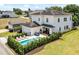 Two-story home with pool and detached garage; lush landscaping at 7423 Sparkling Ct, Reunion, FL 34747
