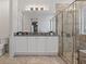 Elegant bathroom with granite countertop, white cabinets, and a large glass shower at 7423 Sparkling Ct, Reunion, FL 34747