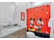 Bathroom with granite countertop, Mickey Mouse shower curtain, and a modern vanity at 7423 Sparkling Ct, Reunion, FL 34747