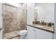 Simple bathroom with granite countertop, white cabinets, and a shower at 7423 Sparkling Ct, Reunion, FL 34747