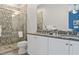Bathroom boasting granite countertops, white cabinets and a walk-in shower at 7423 Sparkling Ct, Reunion, FL 34747