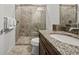 Clean bathroom with granite countertop and a large walk-in shower at 7423 Sparkling Ct, Reunion, FL 34747