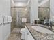 Clean bathroom with granite countertop and a walk-in shower at 7423 Sparkling Ct, Reunion, FL 34747