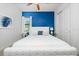 Bedroom with a queen-size bed and blue accent wall at 7423 Sparkling Ct, Reunion, FL 34747