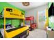 Bright bedroom with bunk beds designed as cars and a school bus, offering playful and functional sleeping space at 7423 Sparkling Ct, Reunion, FL 34747