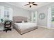 Bedroom with a comfortable king-size bed, a desk, and large windows letting in natural light at 7423 Sparkling Ct, Reunion, FL 34747