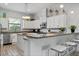 Modern kitchen with white cabinets and granite countertops at 7423 Sparkling Ct, Reunion, FL 34747