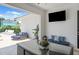 Covered patio with seating and a large TV at 7423 Sparkling Ct, Reunion, FL 34747