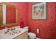 Charming floral bathroom with sink, toilet and mirror at 1000 Dunhurst Ct, Longwood, FL 32779