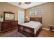 Comfortable bedroom with wooden sleigh bed and hardwood floors at 1000 Dunhurst Ct, Longwood, FL 32779