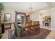 Formal dining room featuring a wood table, chandelier, and view into the foyer at 1000 Dunhurst Ct, Longwood, FL 32779