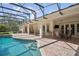 Inviting pool area with covered patio, brick pavers, and lush landscaping at 1000 Dunhurst Ct, Longwood, FL 32779