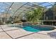 Relaxing screened pool with tiled deck and tropical landscaping at 1000 Dunhurst Ct, Longwood, FL 32779