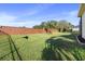 Landscaped backyard with a brick wall and lush green grass at 1011 Johns Cove Ln, Oakland, FL 34787