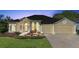 Beautiful one-story home with a three-car garage and lush landscaping at 1011 Johns Cove Ln, Oakland, FL 34787