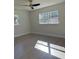 Simple bedroom with hardwood floors and large windows at 12617 Pine Island Dr, Leesburg, FL 34788