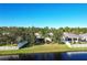 Aerial view of a house with a fenced backyard and a pond at 149 Springberry Ct, Daytona Beach, FL 32124