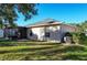 View of the back of a house with a screened patio and fenced yard at 149 Springberry Ct, Daytona Beach, FL 32124