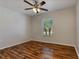 Empty bedroom with wood-look laminate flooring and a ceiling fan at 149 Springberry Ct, Daytona Beach, FL 32124