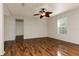 Spacious bedroom with wood-look flooring, a ceiling fan, and a large window with blinds at 149 Springberry Ct, Daytona Beach, FL 32124