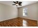 Spacious bedroom with wood-look flooring, a ceiling fan, and a large window at 149 Springberry Ct, Daytona Beach, FL 32124