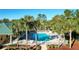 Community pool surrounded by palm trees and lounge chairs at 149 Springberry Ct, Daytona Beach, FL 32124