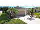 Concrete driveway leading to a two-car garage and the entrance to a home at 149 Springberry Ct, Daytona Beach, FL 32124