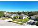 Aerial view of a home with a gray tiled roof, landscaped yard, and attached garage at 149 Springberry Ct, Daytona Beach, FL 32124