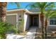 Front exterior of a single-story home with a covered entryway, landscaped yard, and palm trees at 149 Springberry Ct, Daytona Beach, FL 32124