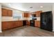 Modern kitchen featuring wood cabinetry, black appliances, and ample counter space at 149 Springberry Ct, Daytona Beach, FL 32124