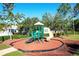 Community playground with slide and climbing features at 149 Springberry Ct, Daytona Beach, FL 32124